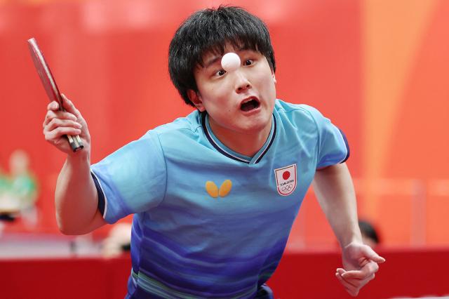Japan's Tomokazu Harimoto hits a return to China's Wang Chuqin in their singles match men's team table tennis final during the 2026 Asian Games at the Toyota City General Gymnasium in Aichi on September 24, 2026. (Photo by JIJI Press / AFP) / Japan OUT