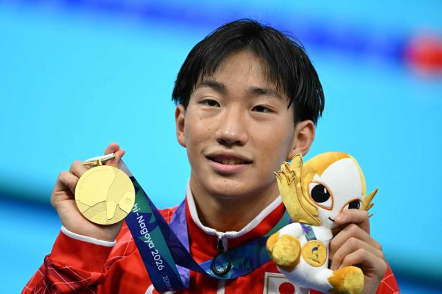 Gold medallist and world record holder Japan's Shin Ohashi celebrates following the victory ceremony of the men's 200m breaststroke swimming event during the 2026 Asian Games at the Tokyo Aquatics Centre in Tokyo on September 24, 2026. (Photo by ANDREW CABALLERO-REYNOLDS / AFP)