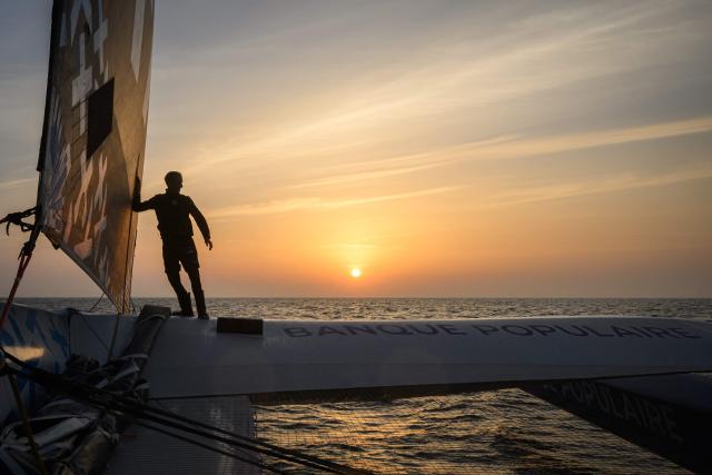 (FILES) French skipper Armel Le Cleac'h sails his Ultim multihull Banque Populaire during a training session from Bordeaux to Lorient ahead of the Route du Rhum solo transatlantic sailing race from Saint-Malo to Pointe-a-Pitre, on May 29, 2026. The water slaps against the enormous trimaran as it speeds across a glassy sea. The 12-hour, 400-km night crossing of the Bay of Biscay is just a “tiny” training exercise for Armel Le Clйac’h. Yet it is essential to his “meticulous” preparation for the upcoming Route du Rhum. On this May 20216 evening, the winner of the 2016–2017 Vendee Globe has switched into competition mode, with his sights set on November 1, the start date of the 13th edition of the Route du Rhum. (Photo by Loic VENANCE / AFP)