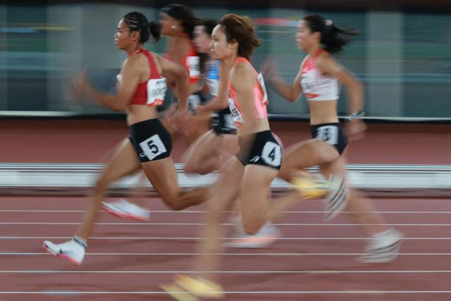 Japan's Midori Mikase (C) competes in the women's 100m heat during the 2026 Asian Games at Nagoya City Mizuho Park Athletic Stadium in Nagoya, Aichi Prefecture on September 24, 2026. (Photo by DAVID GRAY / AFP)
