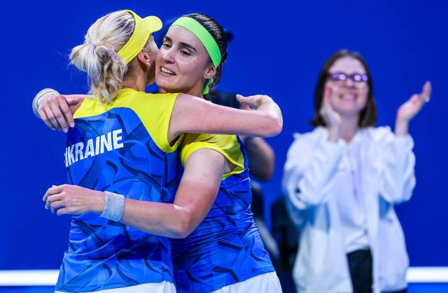Ukraine's Anhelina Kalinina (R) hugs Lyudmyla Kichenok (L) after winning against Belgium's Magali Kempen and Lara Salden during their women's doubles quarter-final match at the Billie Jean King Cup tennis tournament in Shenzhen, southern China's Guangdong province on September 24, 2026. (Photo by CN-STR / AFP) / China OUT