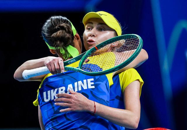 Ukraine's Anhelina Kalinina (L) hugs Lyudmyla Kichenok (R) after winning against Belgium's Magali Kempen and Lara Salden during their women's doubles quarter-final match at the Billie Jean King Cup tennis tournament in Shenzhen, southern China's Guangdong province on September 24, 2026. (Photo by CN-STR / AFP) / China OUT