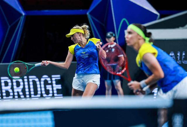 Ukraine's Lyudmyla Kichenok (L) hits a return next to Anhelina Kalinina RL) to Belgium's Magali Kempen and Lara Salden during their women's doubles quarter-final match at the Billie Jean King Cup tennis tournament in Shenzhen, southern China's Guangdong province on September 24, 2026. (Photo by CN-STR / AFP) / China OUT
