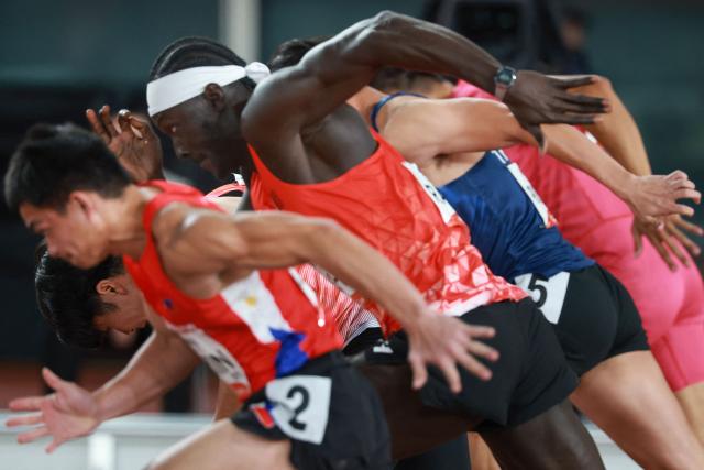 Athletes compete in the men's 100m heat during the 2026 Asian Games at Nagoya City Mizuho Park Athletic Stadium in Nagoya, Aichi Prefecture on September 24, 2026. (Photo by DAVID GRAY / AFP)