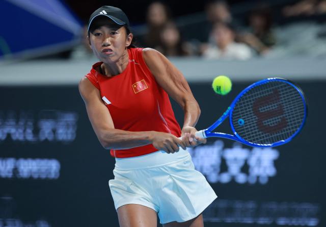 China's Zhang Shuai hits a return to Italy's Elisabetta Cocciaretto during their women's singles quarter-final match at the Billie Jean King Cup tennis tournament in Shenzhen, southern China's Guangdong province on September 24, 2026. (Photo by CN-STR / AFP) / China OUT