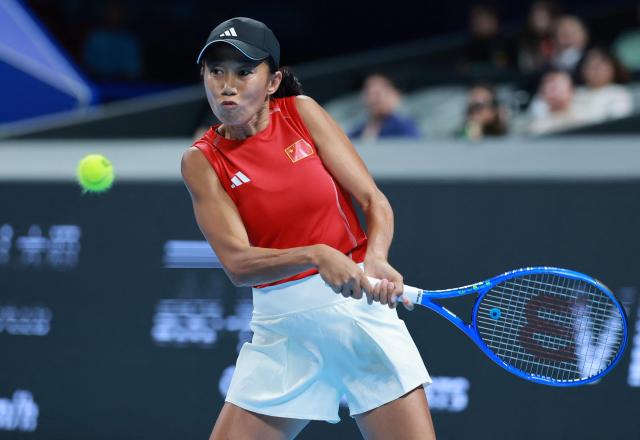 China's Zhang Shuai hits a return to Italy's Elisabetta Cocciaretto during their women's singles quarter-final match at the Billie Jean King Cup tennis tournament in Shenzhen, southern China's Guangdong province on September 24, 2026. (Photo by CN-STR / AFP) / China OUT