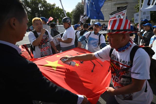 Demonstrators deface Chinese flag during a protest against Chinese President Xi's state visit in Washington, DC, on September 24, 2026. President Xi is on a State visit to the United States from September 23 to 25. (Photo by Mandel NGAN / AFP)