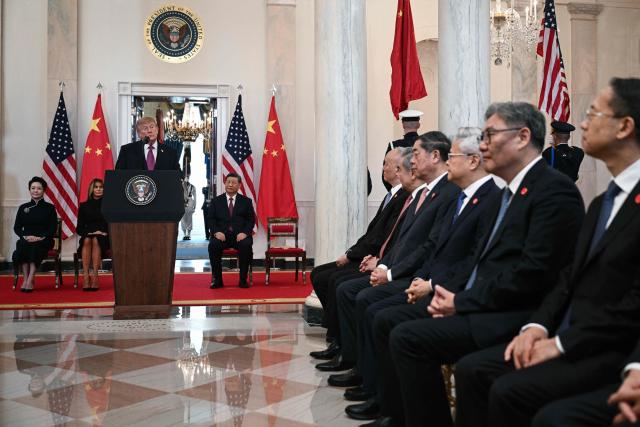 The Chinese delegation (R) listens as US President Donald Trump speaks alongside US First Lady Melania Trump, China's First Lady Peng Liyuan, and China's President Xi Jinping, in the Cross Hall of the White House in Washington, DC, on September 24, 2026. President Xi is on a State visit to the United States from September 23 to 25. (Photo by Brendan SMIALOWSKI / AFP)