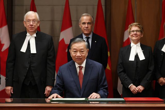 Vietnamese President To Lam signs a guest book during a welcoming ceremony with Canada's Prime Minister Mark Carney at the Parliament of Canada September 24, 2026 in Ottawa, Canada. (Photo by Dave Chan / AFP)