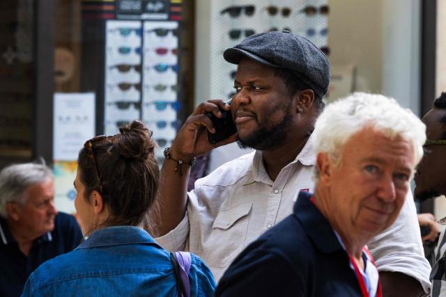Canadian-Haitian novelist Thelyson Orelien speaks on the phone as he takes part in the 28th edition of "Les Correspondances" literature festival in Manosque, south-eastern France on September 24, 2026. (Photo by JOEL SAGET / AFP)
