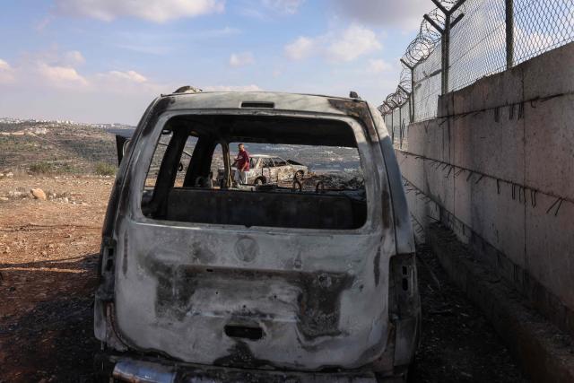 A Palestinian man inspects burnt vehicles after they were allegedly torched by Israeli settlers in Atara village, north of Ramallah in the Israeli-occupied West Bank on September 24, 2026. Violence has surged in the West Bank, occupied by Israel since 1967, after Hamas's October 2023 attack sparked the war in Gaza. Recent months have seen soaring attacks by Israeli settlers against Palestinians, often with little or no legal consequence. (Photo by Zain JAAFAR / AFP)