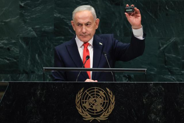 Israel's Prime Minister Benjamin Netanyahu holds up a pager as he speaks during the 81st United Nations General Assembly at the United Nations Headquarters in New York, on September 24, 2026. (Photo by TIMOTHY A. CLARY / AFP)