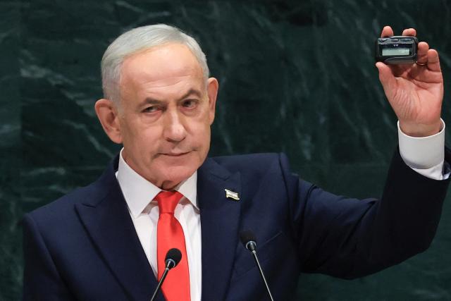 Israel's Prime Minister Benjamin Netanyahu holds up a pager as he speaks during the 81st United Nations General Assembly at the United Nations Headquarters in New York, on September 24, 2026. (Photo by TIMOTHY A. CLARY / AFP)