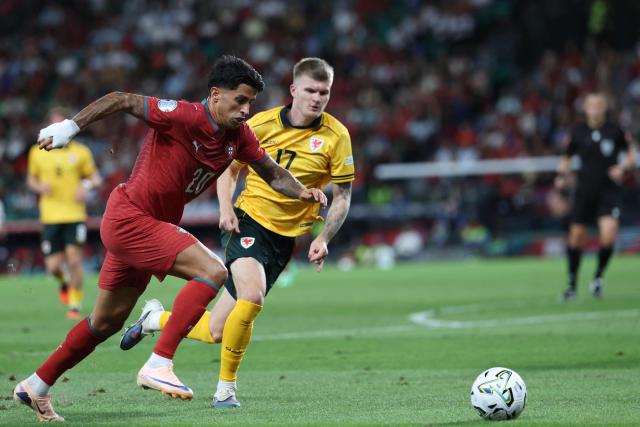 Portugal's defender #20 Joao Cancelo (L) and Wales' midfielder #17 Jordan James fight for the ball during the UEFA Nations League league phase group A4 football match between Portugal and Wales at Jose Alvalade stadium in Lisbon on September 24, 2026. (Photo by PATRICIA DE MELO MOREIRA / AFP)