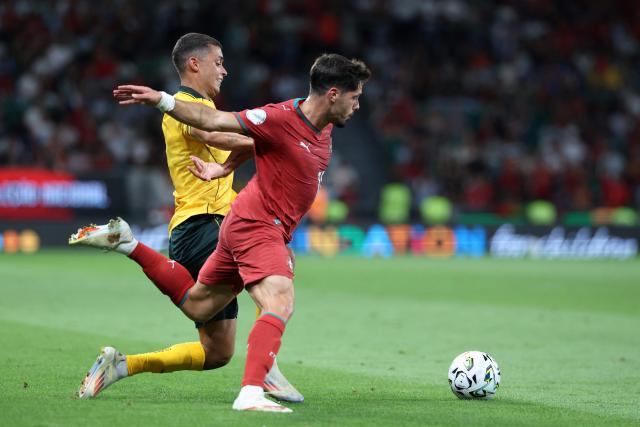 Wales' forward #11 Brennan Johnson (L) and Portugal's forward #18 Pedro Neto fight for the ball during the UEFA Nations League league phase group A4 football match between Portugal and Wales at Jose Alvalade stadium in Lisbon on September 24, 2026. (Photo by PATRICIA DE MELO MOREIRA / AFP)