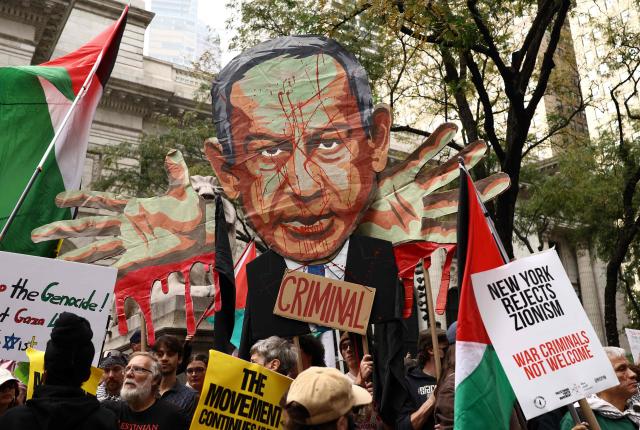 Protesters hold an image of Israeli Prime Minister Benjamin Netanyahu bearing the word "Criminal" above a crowd waving Palestinian flags and holding "Free Palestine" signs during a demonstration on the day of his address to the 81st United Nations General Assembly in New York, on September 24, 2026. (Photo by CHARLY TRIBALLEAU / AFP)