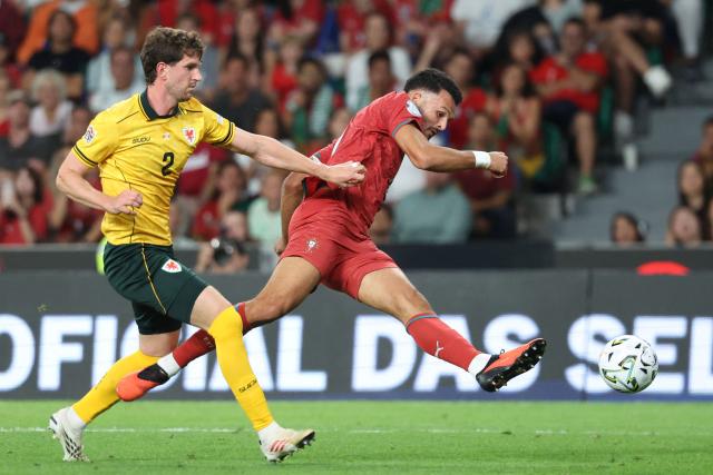Portugal's forward #09 Goncalo Ramos (R) shoots past Wales' defender #02 Chris Mepham during the UEFA Nations League league phase group A4 football match between Portugal and Wales at Jose Alvalade stadium in Lisbon on September 24, 2026. (Photo by PATRICIA DE MELO MOREIRA / AFP)
