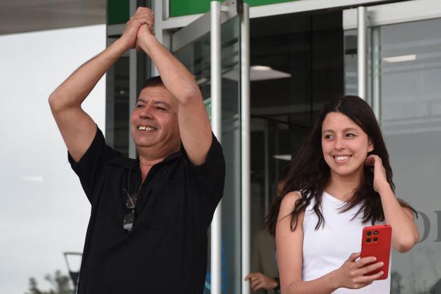 Ariel Lizarraga (L), the father of one of the victims, celebrates with relatives outside a court building after former Japanese nun Kumiko Kosaka was sentenced to 20 years in prison in a case involving the abuse of deaf children in Mendoza, Argentina, on September 24, 2026. (Photo by Andres LARROVERE / AFP)