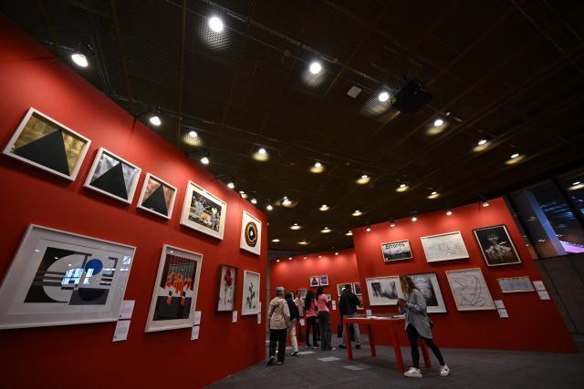 Visitors view artworks at the ARTBO International Art Fair in Bogota on September 24, 2026. (Photo by Raul ARBOLEDA / AFP)