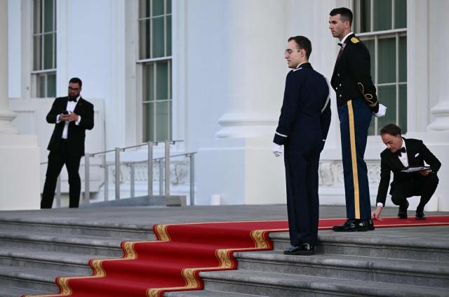 A White House staffer places a position marker for US President Donald Trump ahead of his greeting of Chinese President Xi Jinping and his wife Peng Liyuan at the White House in Washington, DC, on September 24, 2026. President Xi is on a State visit to the United States from September 23 to 25. (Photo by Brendan SMIALOWSKI / AFP)