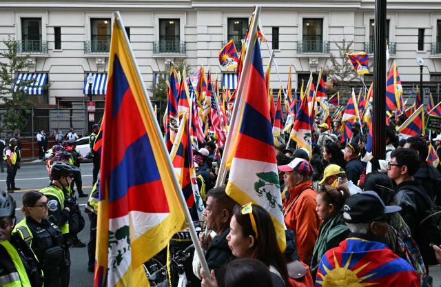 Demonstrators wave Tibetan flags during a protest against Chinese President Xi Jinping during his state visit in Washington, DC, on September 24, 2026. President Xi is on a State visit to the United States from September 23 to 25. (Photo by Alex WROBLEWSKI / AFP)