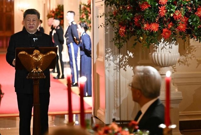 President and CEO of NVIDIA Jensen Huang (R) listens to China's President Xi Jinping speak during a State Dinner in the East Room of the White House in Washington, DC, on September 24, 2026. President Xi is on a State visit to the United States from September 23 to 25. (Photo by Brendan SMIALOWSKI / AFP)