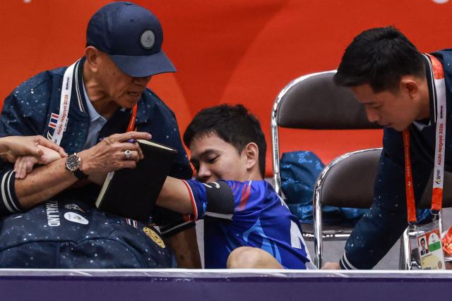 Thailand's Marukin Phanmakon (C) reacts after falling at the back of the court during the men's team regu sepak takraw gold medal finals between Thailand and Malaysia at Nagoya City Mizuho Park Gymnasium in Nagoya on September 25, 2026. (Photo by DAVID GRAY / AFP)
