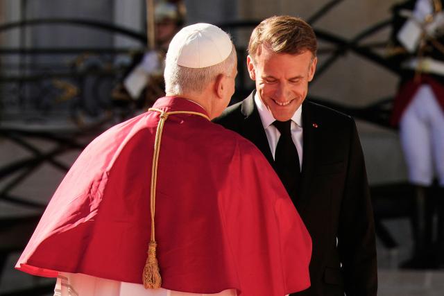 France's President Emmanuel Macron welcomes Pope Leo XIV ahead of a meeting at the Elysee Presidential Palace, in Paris on September 25, 2026 at the start of his four days visit to France. Pope Leo XIV begins an official visit to France on September 25, with several thorny issues hanging over the trip, from clerical sexual abuse to the country's new assisted dying law. (Photo by Teresa SUAREZ / POOL / AFP)