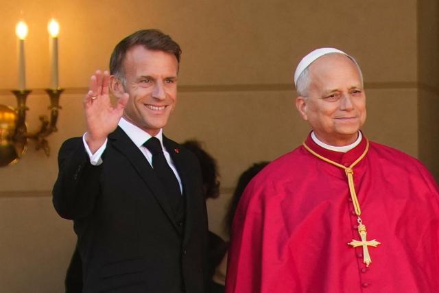 France's President Emmanuel Macron (L) welcomes Pope Leo XIV (R) ahead of a meeting at the Elysee Presidential Palace, in Paris on September 25, 2026 at the start of his four days visit to France. Pope Leo XIV begins an official visit to France on September 25, with several thorny issues hanging over the trip, from clerical sexual abuse to the country's new assisted dying law. (Photo by Teresa SUAREZ / POOL / AFP)