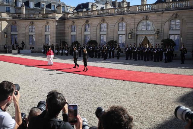 France's President Emmanuel Macron (C) and his wife Brigitte welcome Pope Leo XIV (L) ahead of a meeting at the Elysee Presidential Palace, in Paris on September 25, 2026 at the start of his four days visit to France. Pope Leo XIV begins an official visit to France on September 25, with several thorny issues hanging over the trip, from clerical sexual abuse to the country's new assisted dying law. (Photo by Ludovic MARIN / AFP)