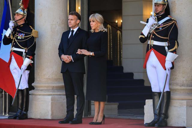 France's President Emmanuel Macron (L) and his wife Brigitte Macron (R) wait for the arrival of Pope Leo XIV ahead of a meeting at the Elysee Presidential Palace, in Paris on September 25, 2026 at the start of his four days visit to France. Pope Leo XIV begins an official visit to France on September 25, with several thorny issues hanging over the trip, from clerical sexual abuse to the country's new assisted dying law. (Photo by Ludovic MARIN / AFP)