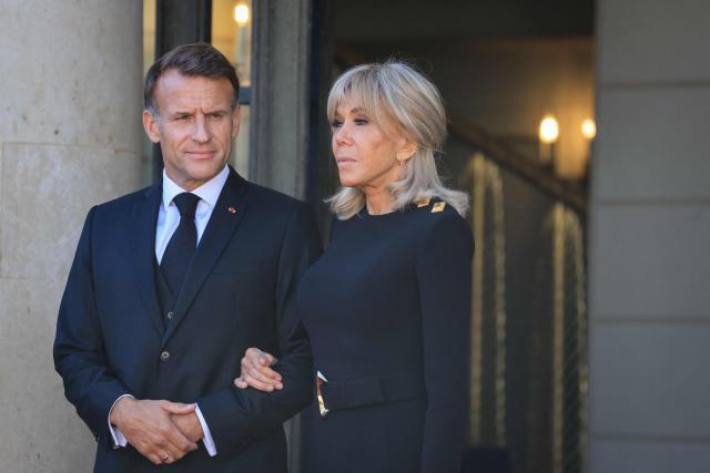France's President Emmanuel Macron (L) and his wife Brigitte Macron (R) wait for the arrival of Pope Leo XIV ahead of a meeting at the Elysee Presidential Palace, in Paris on September 25, 2026 at the start of his four days visit to France. Pope Leo XIV begins an official visit to France on September 25, with several thorny issues hanging over the trip, from clerical sexual abuse to the country's new assisted dying law. (Photo by Ludovic MARIN / AFP)