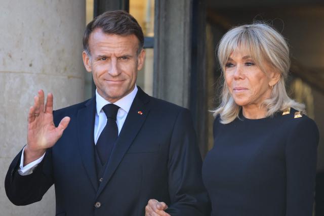 France's President Emmanuel Macron (L) and his wife Brigitte Macron (R) wait for the arrival of Pope Leo XIV ahead of a meeting at the Elysee Presidential Palace, in Paris on September 25, 2026 at the start of his four days visit to France. Pope Leo XIV begins an official visit to France on September 25, with several thorny issues hanging over the trip, from clerical sexual abuse to the country's new assisted dying law. (Photo by Ludovic MARIN / AFP)