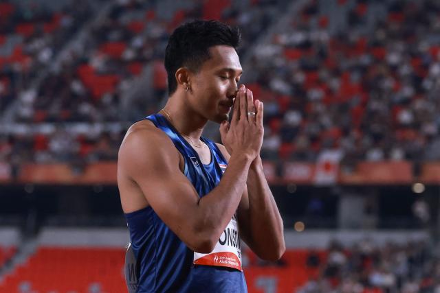 Thailand's Puripol Boonson celebrates after winning the men's 100m semifinal during the 2026 Asian Games at Nagoya City Mizuho Park Athletic Stadium in Nagoya, Aichi Prefecture on September 25, 2026. (Photo by DAVID GRAY / AFP)