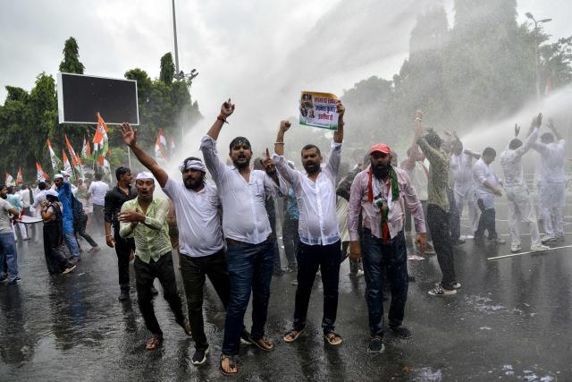 Police personnel use a water cannon to disperse India's Opposition Congress party supporters shouting slogans against India's Chief Election Commissioner Gyanesh Kumar, demanding his resignation during a protest in Patna on September 25, 2026. The Election Commission of India (ECI) has been under scrutiny in recent months over the nationwide revision that has struck millions of names from voter lists since last year. (Photo by Sachin KUMAR / AFP)