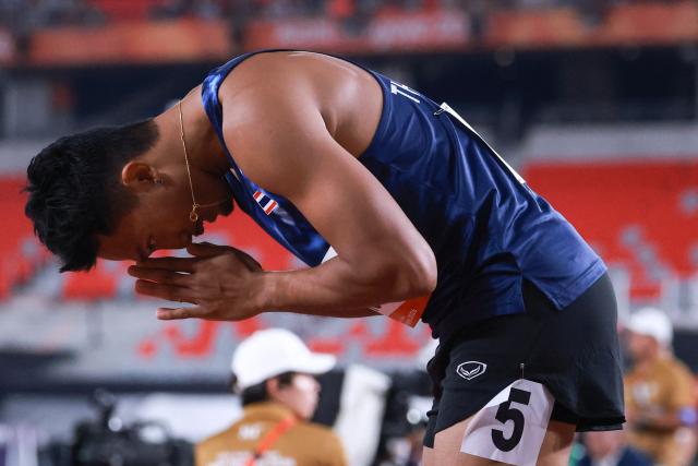 Thailand's Puripol Boonson acknowledges spectators after setting a games record in the men's 100m semifinal during the 2026 Asian Games at Nagoya City Mizuho Park Athletic Stadium in Nagoya, Aichi Prefecture on September 25, 2026. (Photo by DAVID GRAY / AFP)