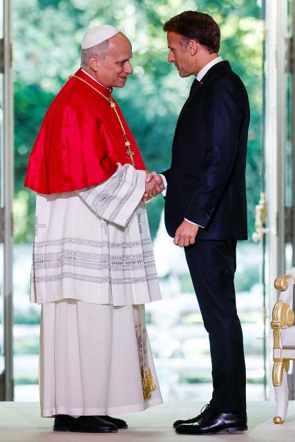 France's President Emmanuel Macron (R) and Pope Leo XIV (L) shake hands during a ceremony following their meeting at the Elysee Presidential Palace, in Paris on September 25, 2026 at the start of Pope's four days visit to France. (Photo by Benoit Tessier / POOL / AFP)
