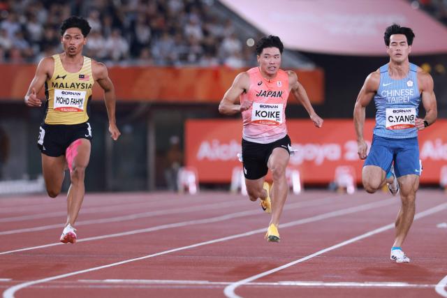 (L-R) Malaysia's Muhd Azeem Fahmi, Japan's Yuki Koike and Taiwan's Yang Chun-han compete in the men's 100m semifinal during the 2026 Asian Games at Nagoya City Mizuho Park Athletic Stadium in Nagoya, Aichi Prefecture on September 25, 2026. (Photo by DAVID GRAY / AFP)
