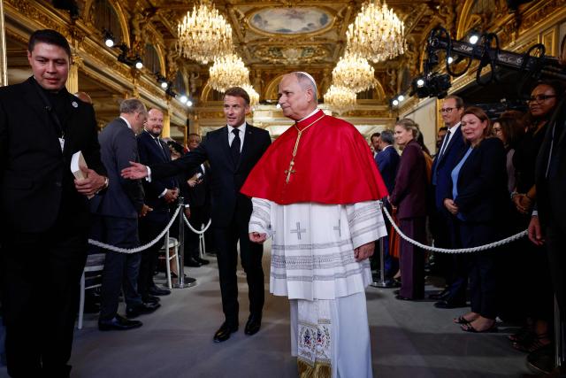 France's President Emmanuel Macron (L) and Pope Leo XIV (R) meet with authorities, members of civil society and the diplomatic corps following their meeting at the Elysee Presidential Palace, in Paris on September 25, 2026 at the start of his four days visit to France. (Photo by Benoit Tessier / POOL / AFP)