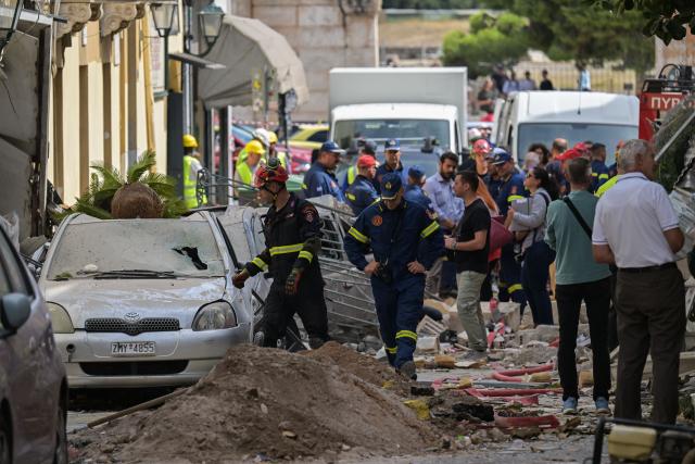 Emergency personnel operate at the site of an old building that partially collapsed following an explosion in the Plaka area of central Athens on September 25, 2026. (Photo by Aris MESSINIS / AFP)