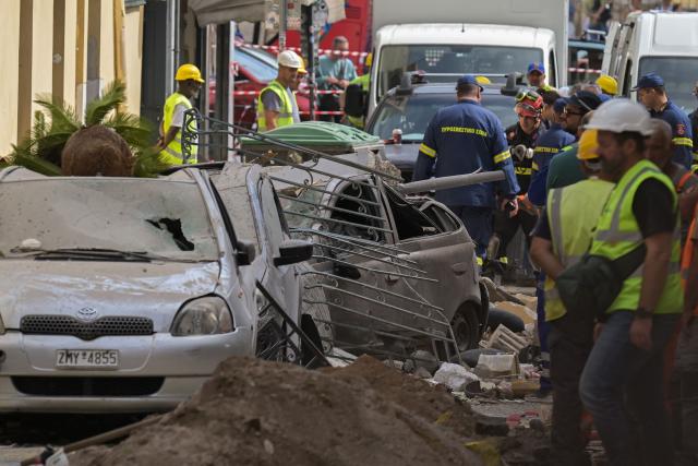 Emergency personnel operate at the site of an old building that partially collapsed following an explosion in the Plaka area of central Athens on September 25, 2026. (Photo by Aris MESSINIS / AFP)