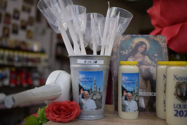 This photograph shows goods with a portrait of Pope Leo XIV dipslayed at a shop in Lourdes, south-western France, a day ahead of the Pope's visit, on September 25, 2026. On the first official papal trip in 18 years to a proudly secular country that has since 1901 separated church and state, Pope Leo will visit Lourdes, a pilgrimage site for Christians worldwide where he will privately meet victims of clerical sex abuse, and Metz, near the German border, where he is to further speak about peace in Europe. (Photo by Ed JONES / AFP)