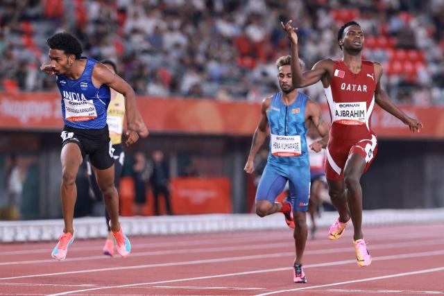 India's Vishal Thennarasu (L) and Qatar's Ammar Ibrahim cross the finish line in the men's 400m heat during the 2026 Asian Games at Nagoya City Mizuho Park Athletic Stadium in Nagoya, Aichi Prefecture on September 25, 2026. (Photo by DAVID GRAY / AFP)