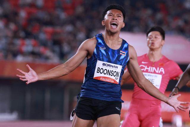 Thailand's Puripol Boonson crosses the finish line to win the men's 100m final during the 2026 Asian Games at Nagoya City Mizuho Park Athletic Stadium in Nagoya, Aichi Prefecture on September 25, 2026. (Photo by DAVID GRAY / AFP)