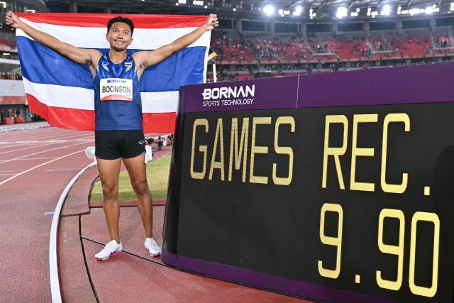 Thailand's Puripol Boonson poses with the time board after setting a new games record in the men's 100m final during the 2026 Asian Games at Nagoya City Mizuho Park Athletic Stadium in Nagoya, Aichi Prefecture on September 25, 2026. (Photo by MOHD RASFAN / AFP)