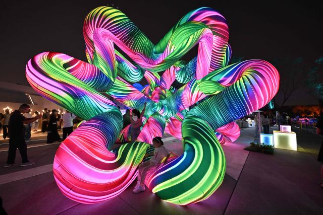 People visit a park during the Mid-Autumn Festival in Beijing on September 25, 2026. (Photo by Adek BERRY / AFP)