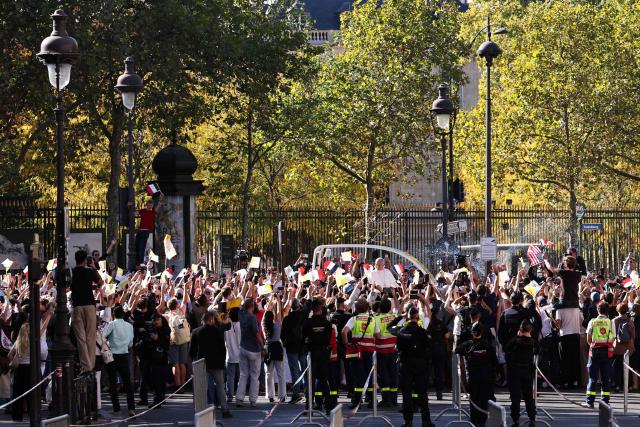 Pope Leo XIV waves to the crowd while riding in the Papamobile (popemobile) along the Jardin du luxembourg in Paris on September 25, 2026 as part of his four days visit to France. (Photo by SIMON WOHLFAHRT / AFP)