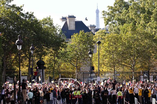 Pope Leo XIV waves to the crowd while riding in the Papamobile (popemobile) along the Jardin du luxembourg in Paris on September 25, 2026 as part of his four days visit to France. (Photo by SIMON WOHLFAHRT / AFP)