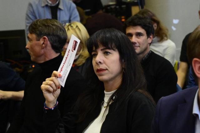 Top candidate for Berlin state elections of the left-wing Die Linke (The Left) party Elif Eralp (C)
votes along with party members during a party congress of the leftist Die Linke Berlin party in Berlin on September 25, 2026. (Photo by Tobias SCHWARZ / AFP)