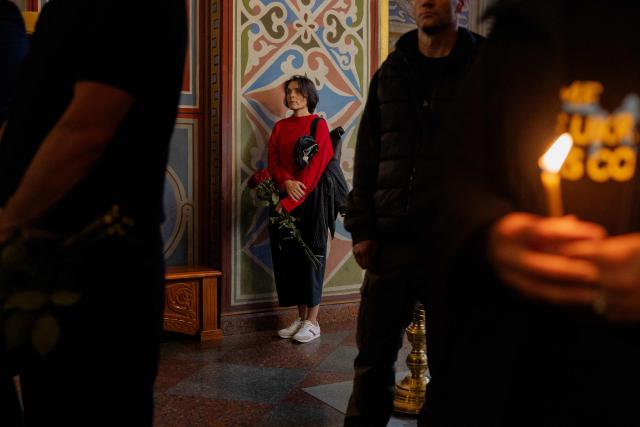 Relatives and friends mourn at the funeral of Mykola Karpyuk, a Ukrainian serviceman, public and political figure and former political prisoner of the Kremlin who was killed in combat during the Russian invasion of Ukraine, at a funeral ceremony in Kyiv on September 25, 2026. (Photo by Tetiana DZHAFAROVA / AFP)